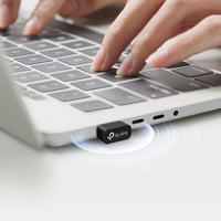 TP-Link Archer TX10UB Nano AX900 Nano Dual Band Wi-Fi 6 Bluetooth 5.3 USB Adapter — in-use, plugged into laptop keyboard edge