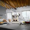 De'Longhi Stilosa Espresso Maker - Cream - in an open-plan kitchen with breakfast