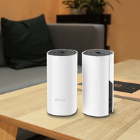 TP-Link Deco M4, two units on a wood table — lifestyle