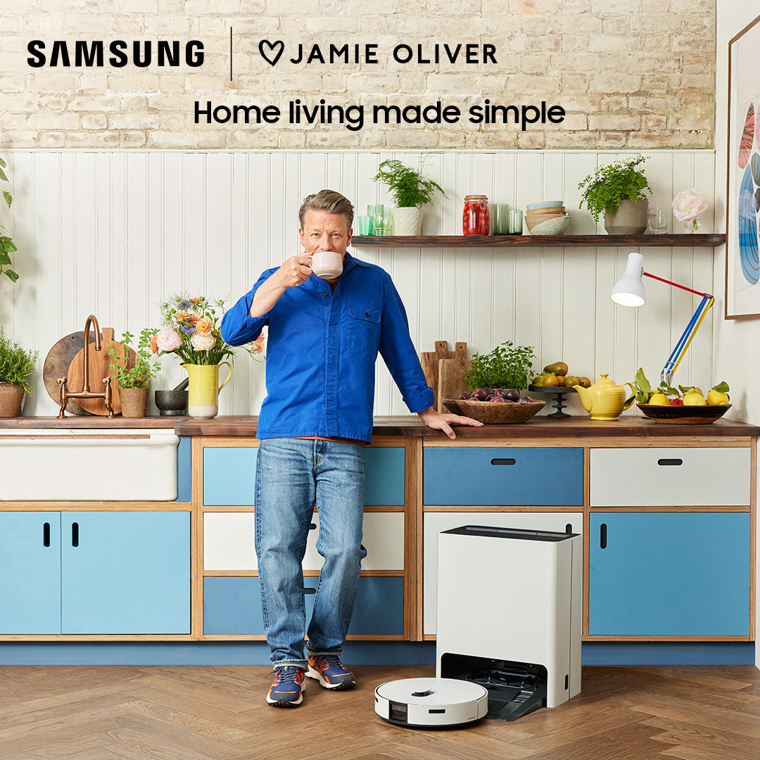 Samsung Bespoke Jet Bot Combo AI+ VR7MD97714G robot vacuum and station in a kitchen with a man standing beside