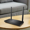 TP-Link Archer VR400, single unit on a wood side table — lifestyle