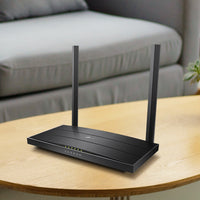 TP-Link Archer VR400, single unit on a wood side table — lifestyle