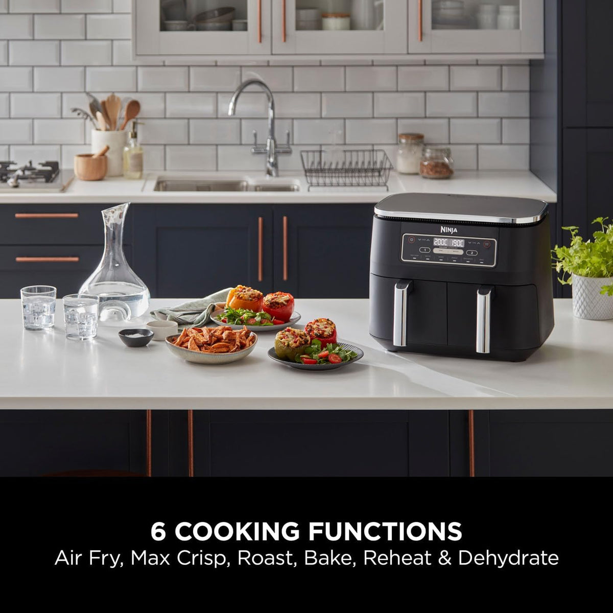 Ninja Foodi Dual Zone AF300UK air fryer on a kitchen worktop beside plates of food