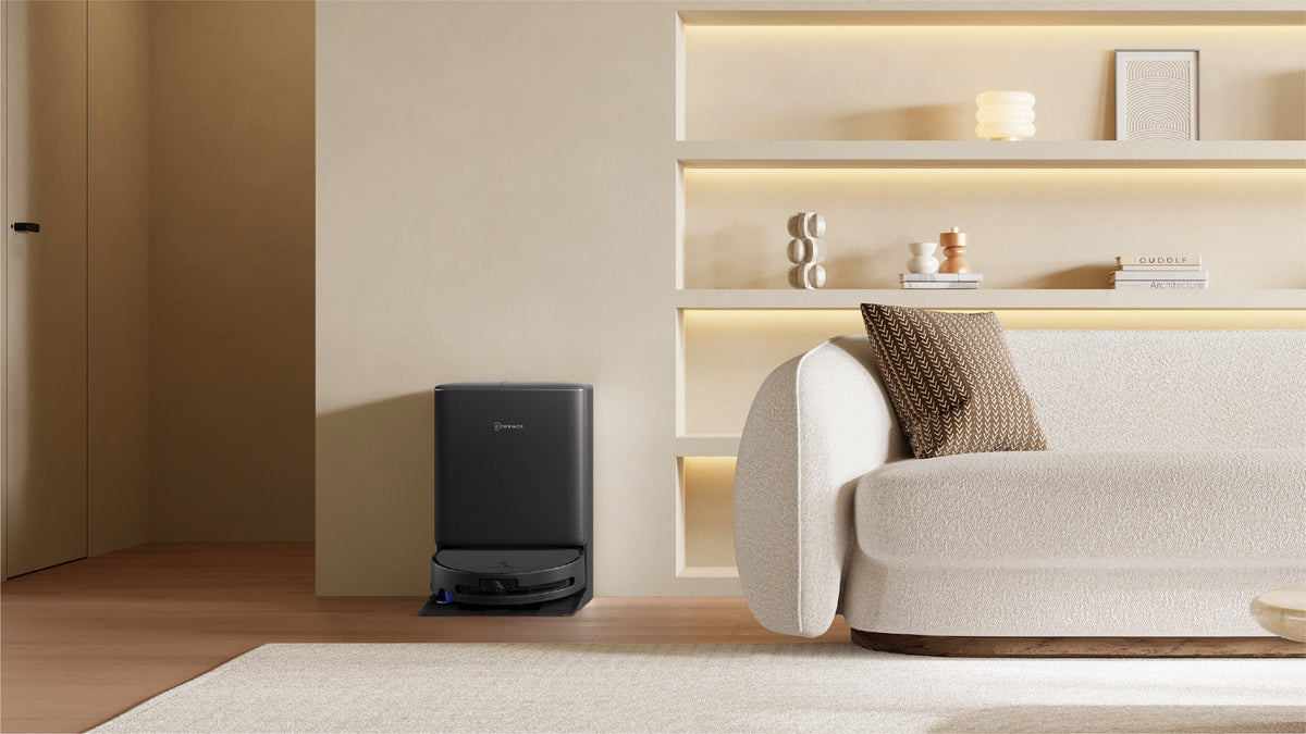 Ecovacs DEEBOT T90 PRO OMNI Robot Vacuum and Mop - Black - station and robot beside a sofa