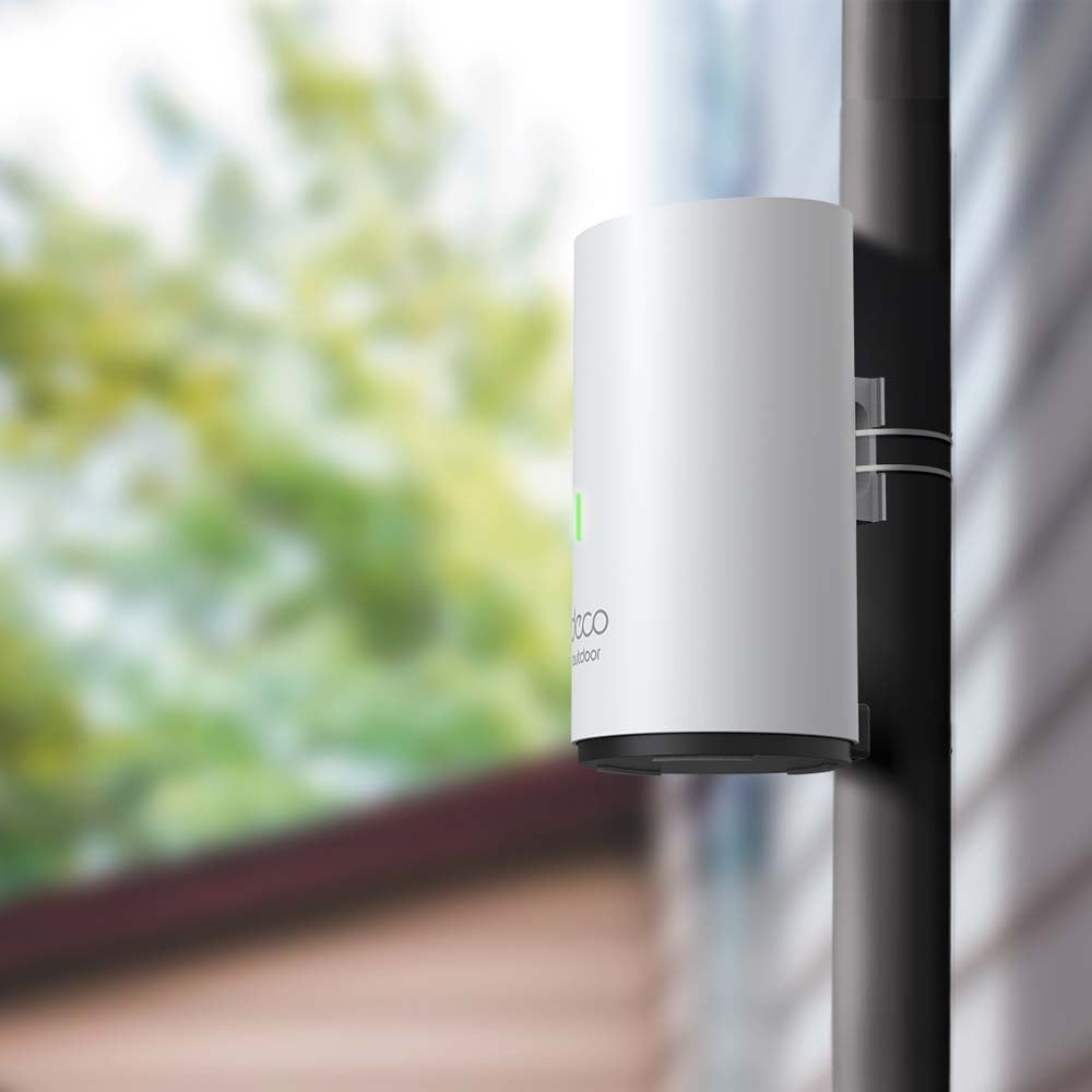 TP-Link Deco X50-Outdoor, single unit mounted on an outdoor railing/pole — lifestyle