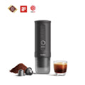 Outin Nano portable espresso machine in Space Grey with ground coffee, coffee capsules and a glass of espresso