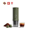 Outin Nano portable espresso machine in Forest Green with ground coffee, coffee capsules and a glass of espresso
