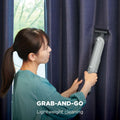 Shark WandVac Deluxe Pet Pro in use with the Duster Crevice Tool cleaning a curtain rail, captioned 'Grab-and-go, lightweight cleaning'