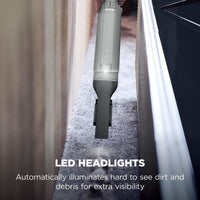 Shark WandVac Deluxe Pet Pro LED headlight illuminated while cleaning a stair edge, captioned 'LED headlights'