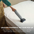 Shark WandVac Deluxe Pet Pro with Motorised Pet Tool head removing pet hair from a mattress, captioned 'Unleash powerful pet hair pick up'