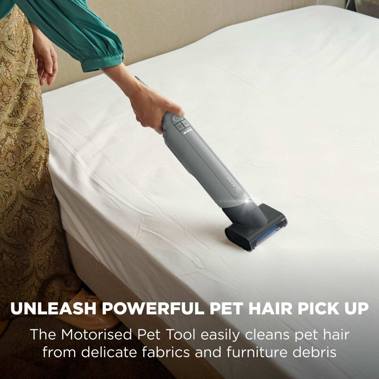 Shark WandVac Deluxe Pet Pro with Motorised Pet Tool head removing pet hair from a mattress, captioned 'Unleash powerful pet hair pick up'