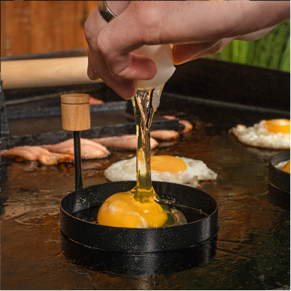 Blackstone 4 Piece Breakfast Kit - cracking an egg into a ring