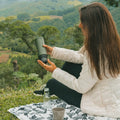 Outin Nano portable espresso machine in Forest Green with ground coffee, coffee capsules and a glass of espresso