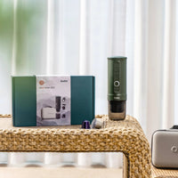 Outin Nano Forest Green portable espresso machine beside its Nano Protective Case with capsule storage