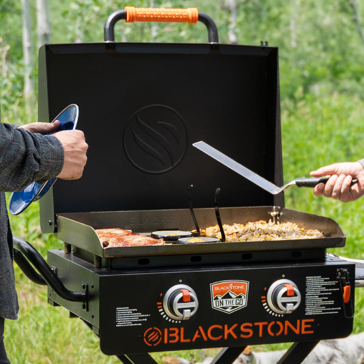 Blackstone On The Go 22" Omnivore Gas Griddle with Hood and Flexfold Legs - Black - cooking with the hood open