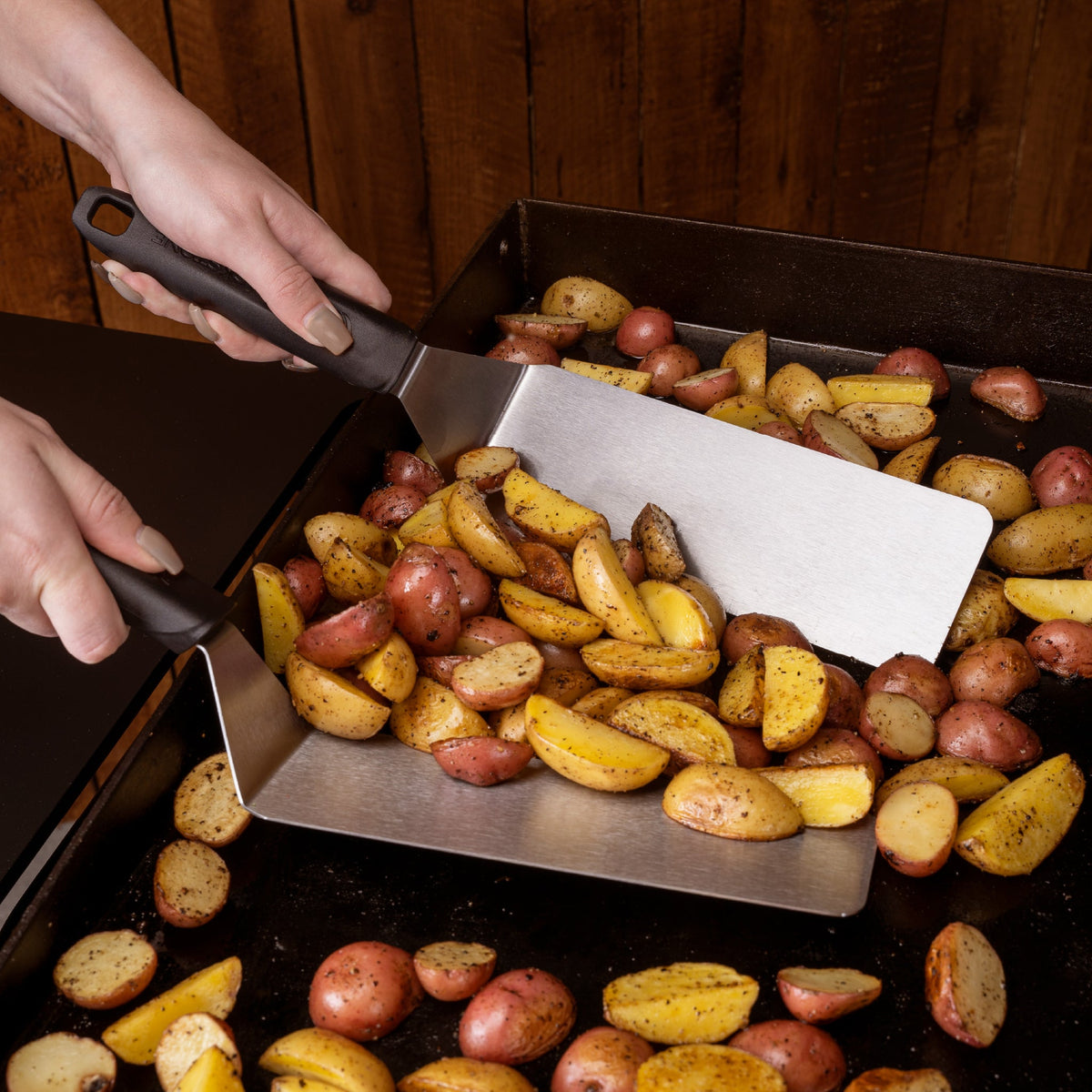 Blackstone 5 Piece Griddle Toolkit - scraping potatoes