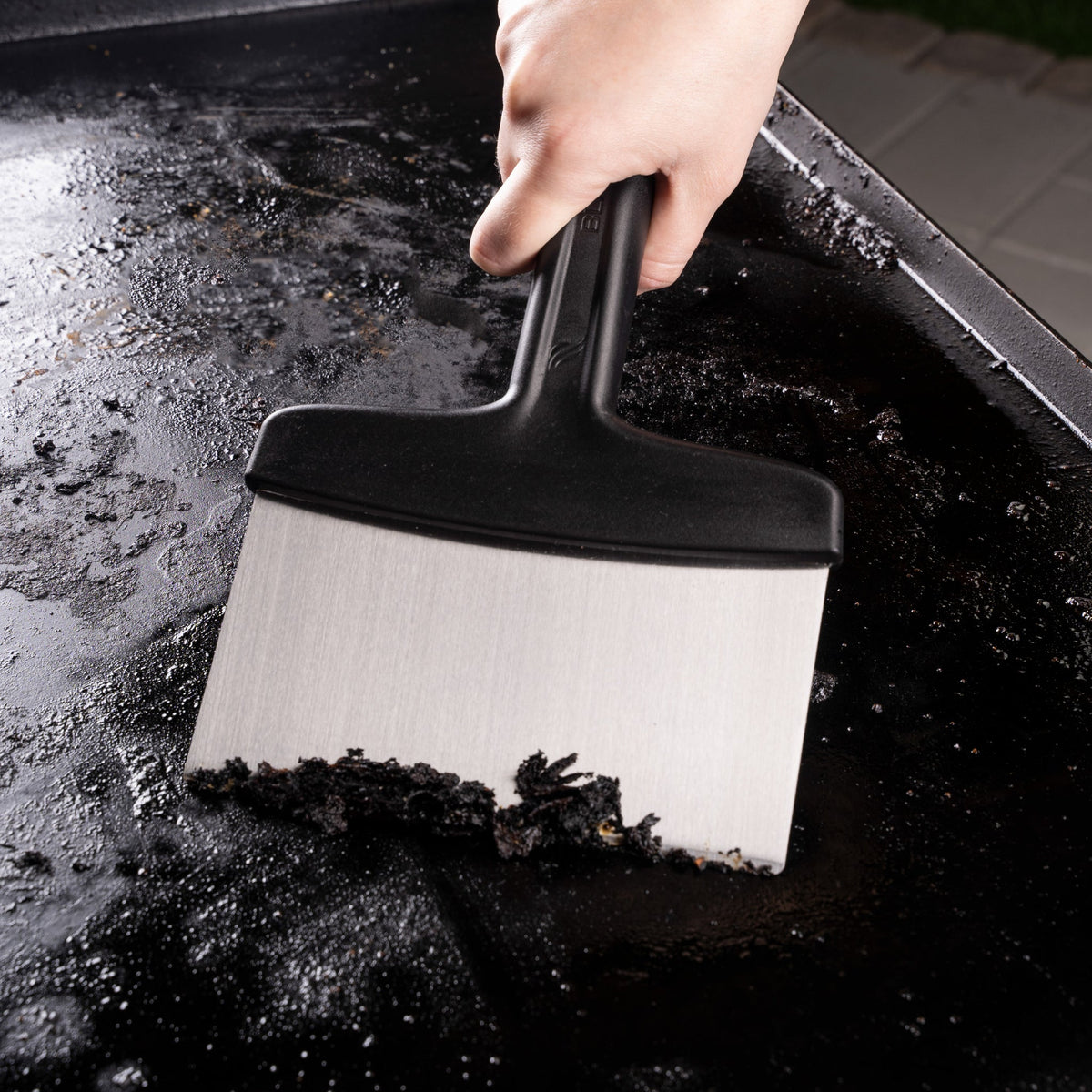 Blackstone 5 Piece Griddle Toolkit - scraper in use