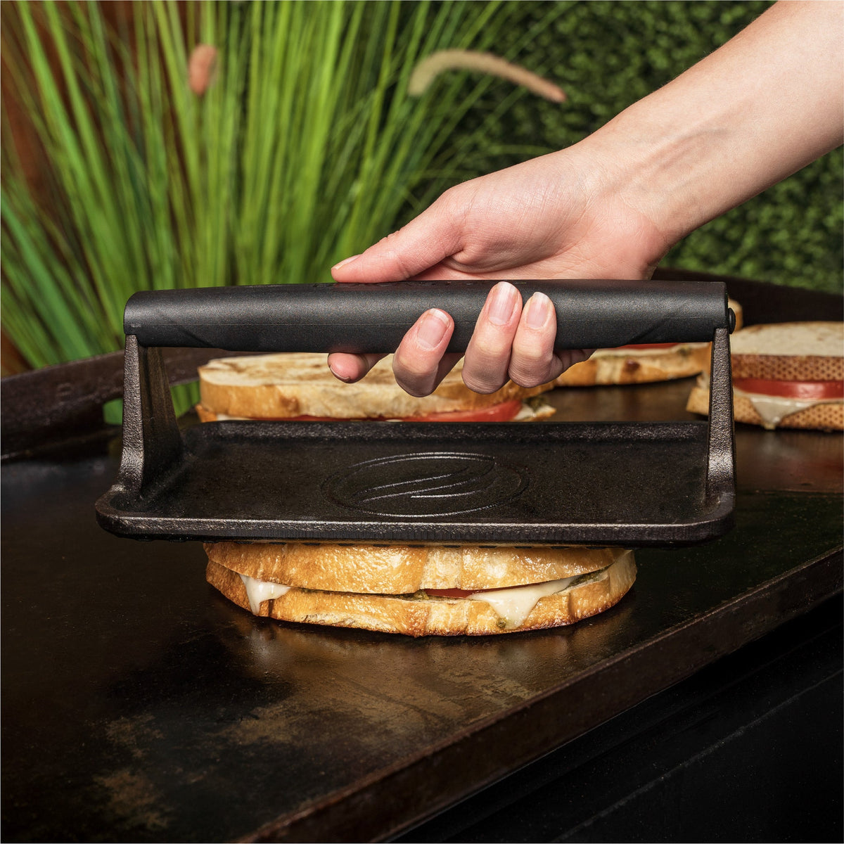 Blackstone Medium Cast Iron Griddle Press - pressing a sandwich