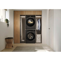 Haier X Series 5 9kg Heat Pump Tumble Dryer - Graphite - in a utility room, stacked above the matching washer
