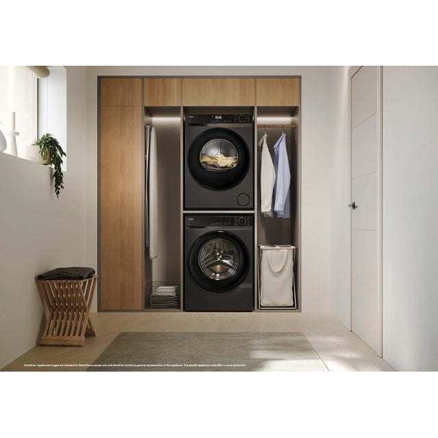 Haier X Series 5 9kg Heat Pump Tumble Dryer - Graphite - in a utility room, stacked above the matching washer