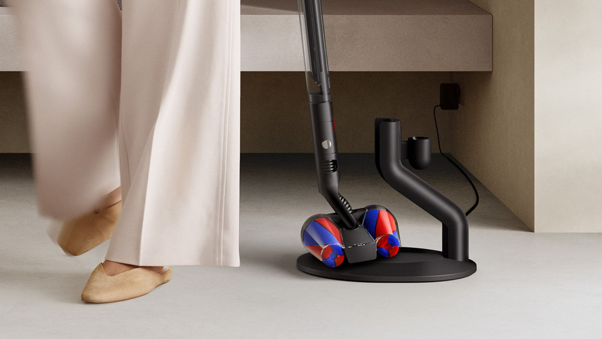 Dyson PencilVac Fluffycones Cordless Vacuum Cleaner - Matte Black - flat under furniture on its dock