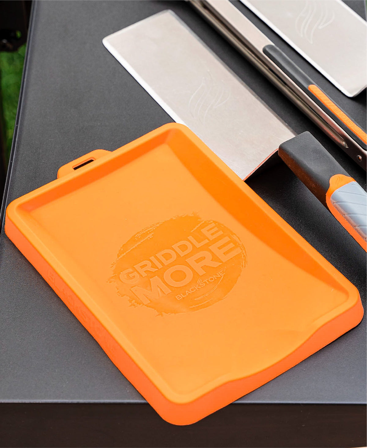 Blackstone Silicone Spatula Mat - Orange - mat holding a scraper