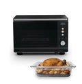 Ninja CRISPi microwave, air fryer and oven in Black on white background, with roast chicken dish