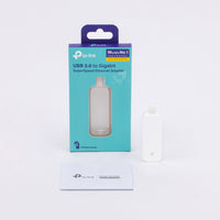TP-Link UE300 USB 3.0 to Gigabit Ethernet Adapter — product with packaging and card laid out