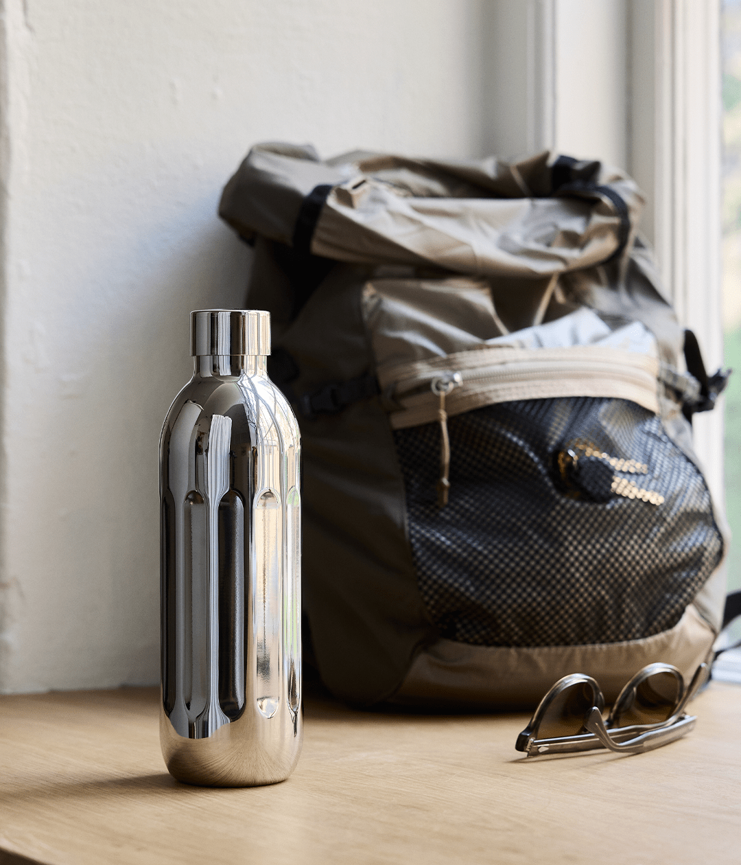 Aarke To-Go Bottle for Carbonator Pro, 500ml — lifestyle shot with backpack