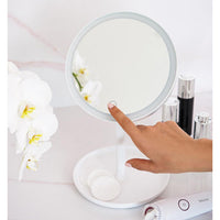 Beurer BS 45 Illuminated Cosmetics Mirror in use, touch sensor being pressed