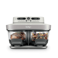 Ninja Crispi DualZone Glass Air Fryer in Bone with steak and roast vegetables in the two zones
