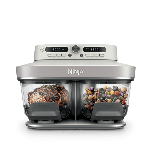 Ninja Crispi DualZone Glass Air Fryer in Bone with steak and roast vegetables in the two zones