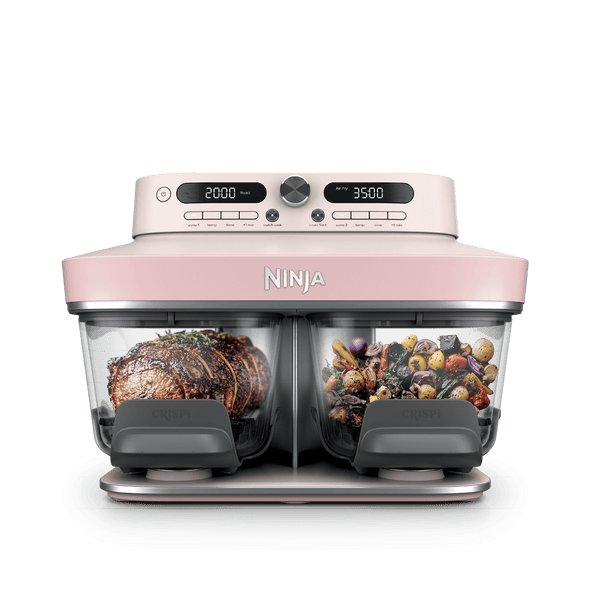 Ninja Crispi DualZone Glass Air Fryer in Rose Quartz with steak and roast vegetables in the two zones