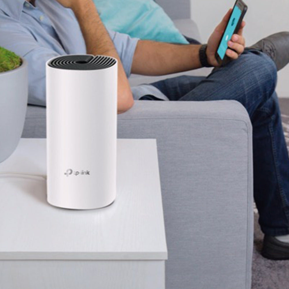 TP-Link Deco M4, single unit on a side table — lifestyle