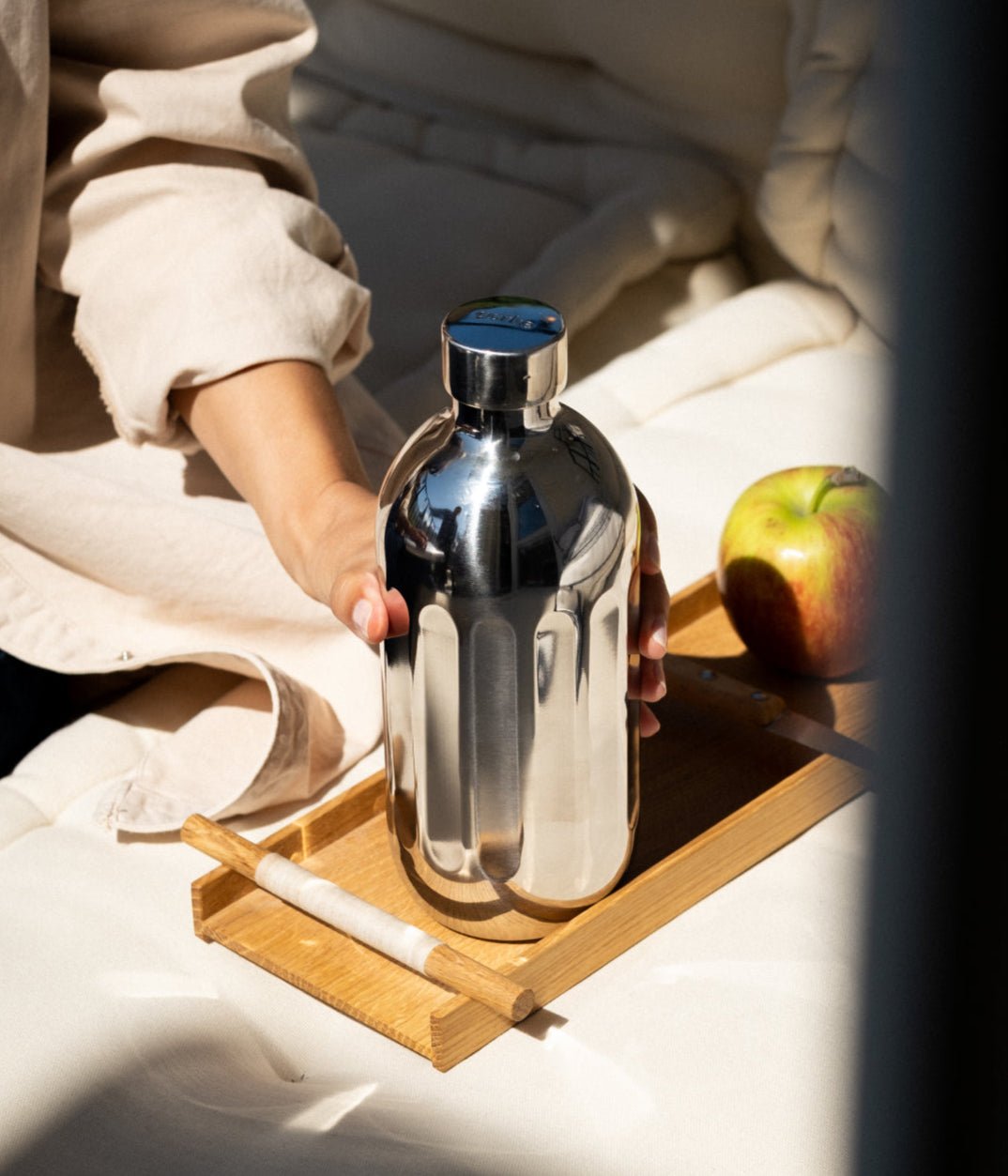 Aarke stainless steel To-Go Bottle for Carbonator Pro — lifestyle shot on a wooden tray