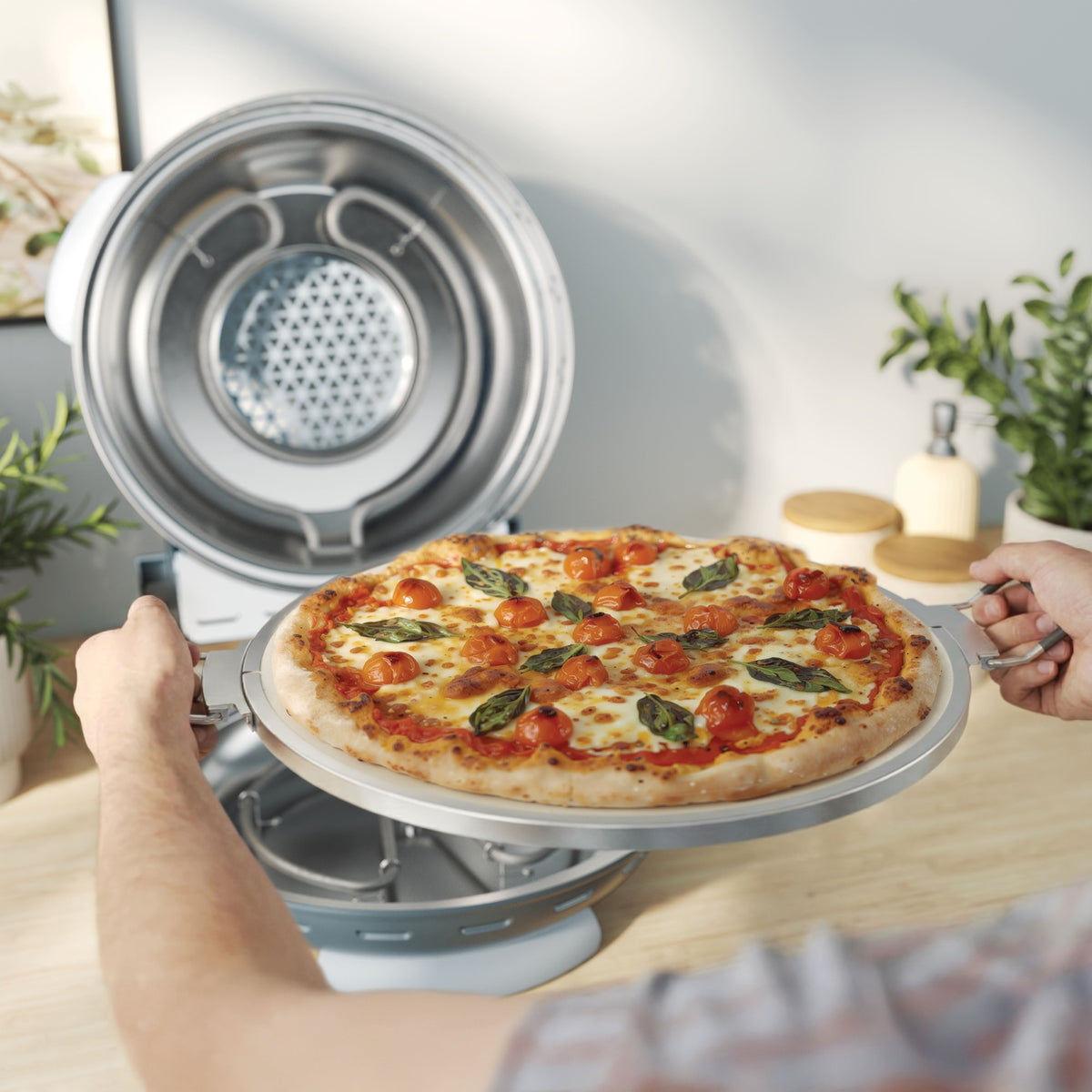 Kenwood My Pizzeria Pizza Oven - Storm Blue - serving a fresh pizza from the oven