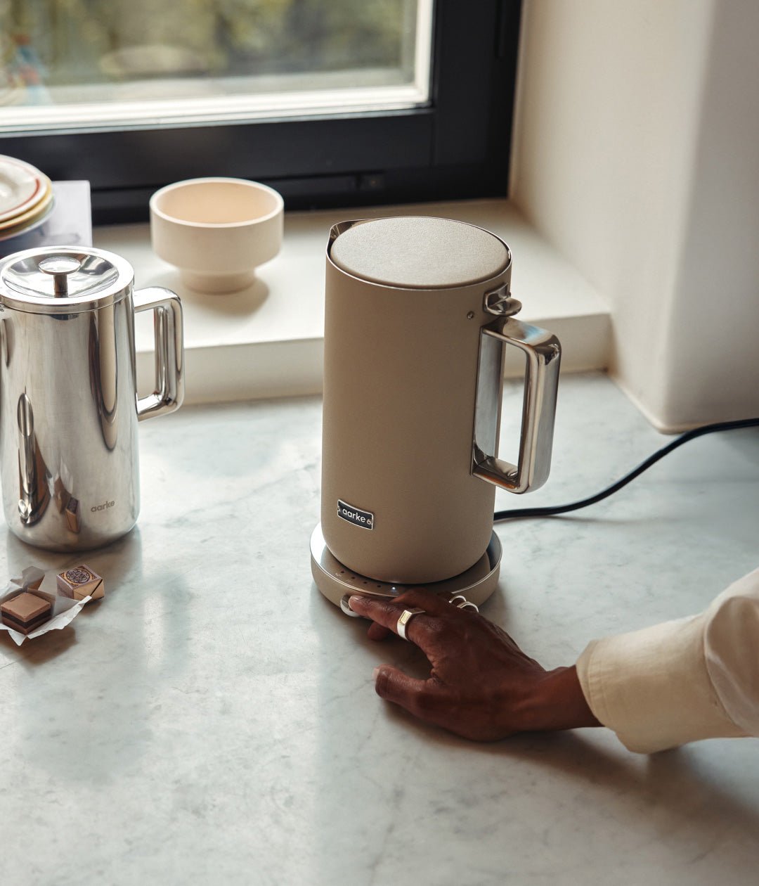 Aarke Temperature Control Kettle in Sand — lifestyle countertop shot