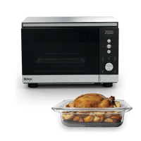 Ninja Crispi Microwave and Air Fryer in Silver with roast chicken in glass dish — front view