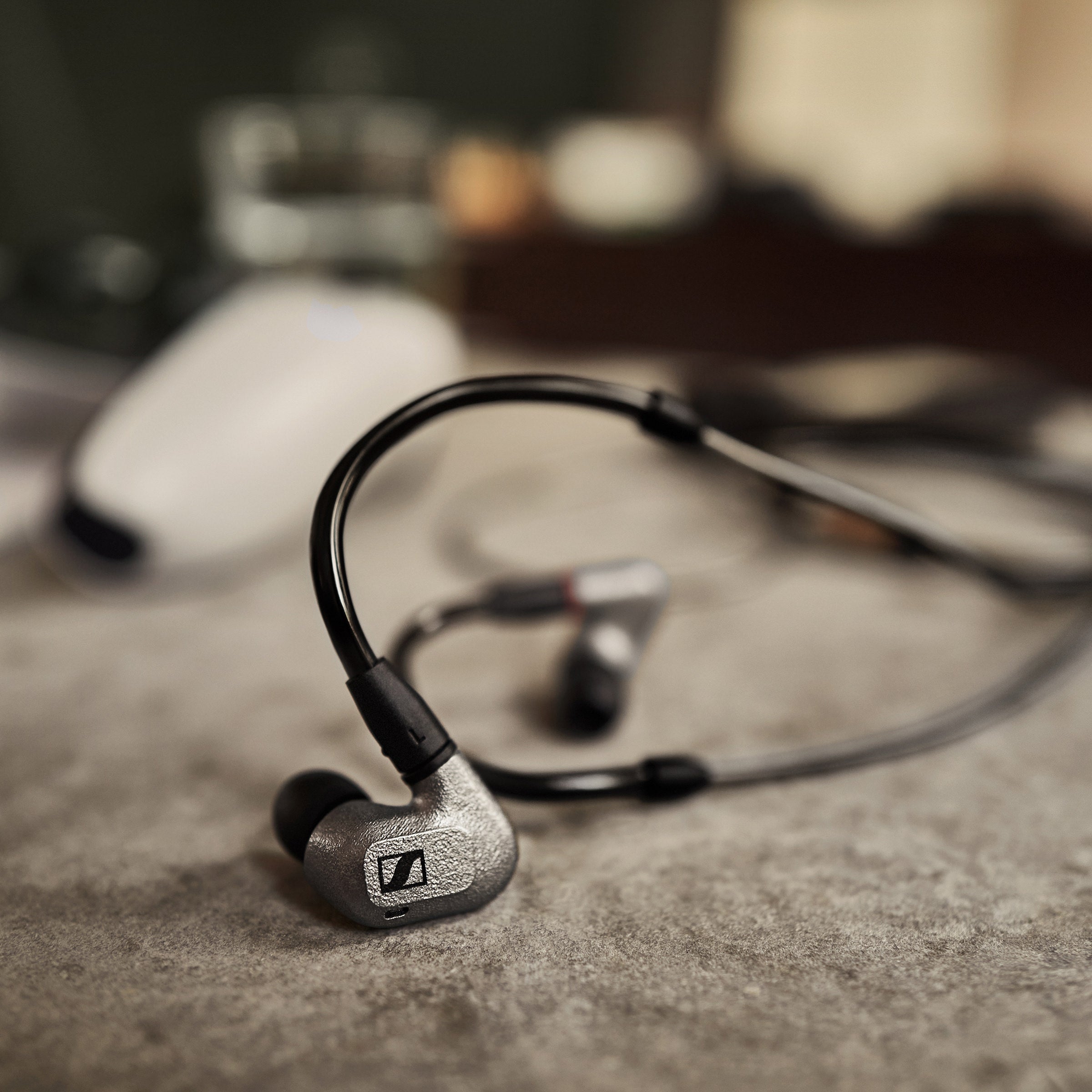 Sennheiser IE 600 Audiophile Earphones — lifestyle still life on a textured tabletop