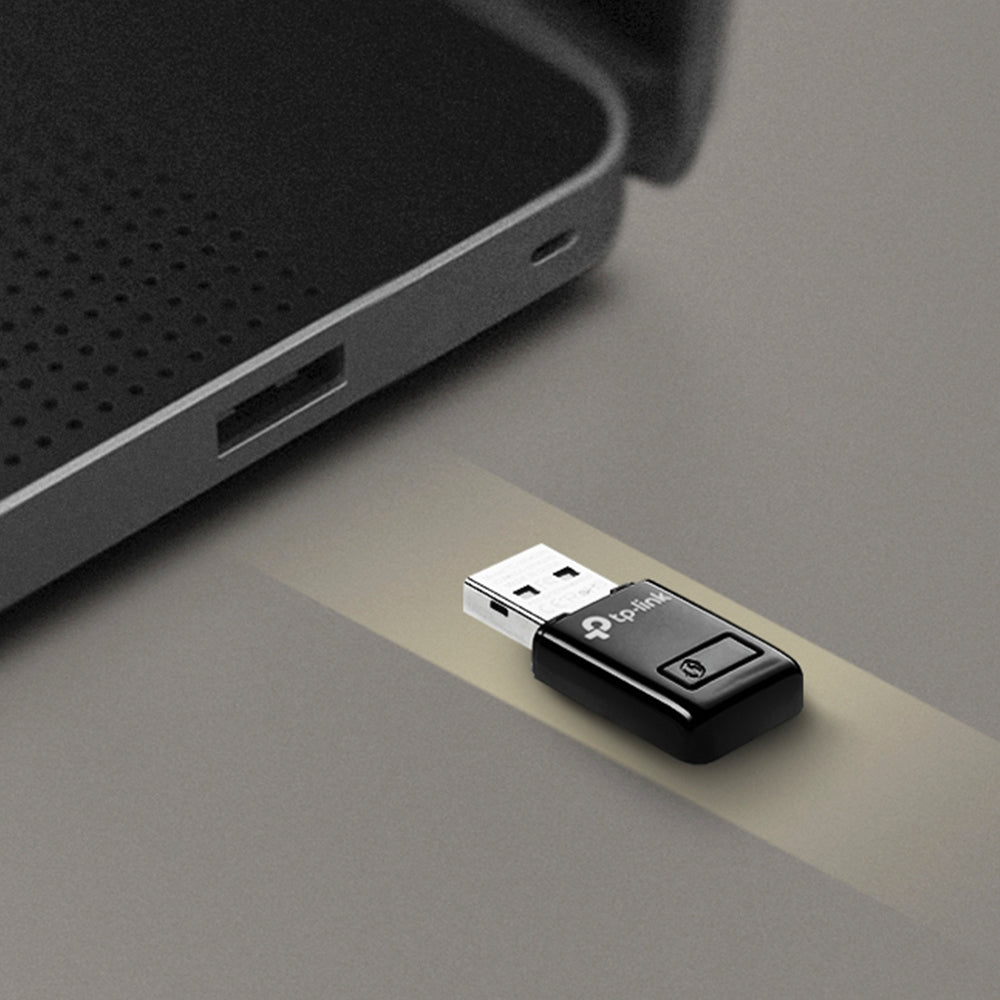TP-Link TL-WN823N N300 Mini Wi-Fi USB Adapter, QSS button — in-use, plugged into laptop