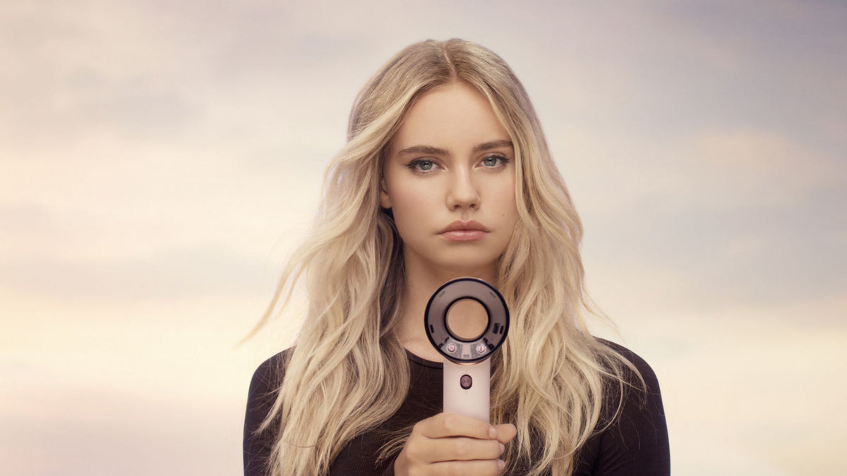 Dyson Supersonic Travel Hair Dryer - Ceramic Pink/Rose Gold - held by a model