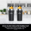 Two Ninja SLUSHi Black insulated bubble cups with straws on a kitchen counter