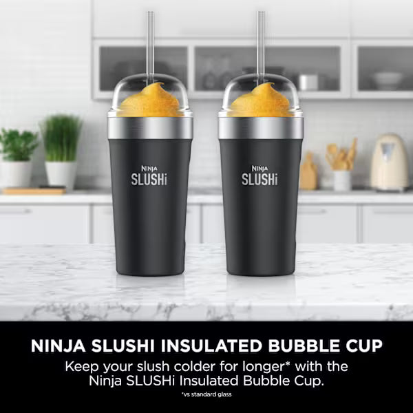Two Ninja SLUSHi Black insulated bubble cups with straws on a kitchen counter
