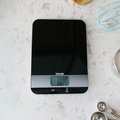 Beurer KS 19 Kitchen Scale Black, top-down view on kitchen counter with measuring spoons