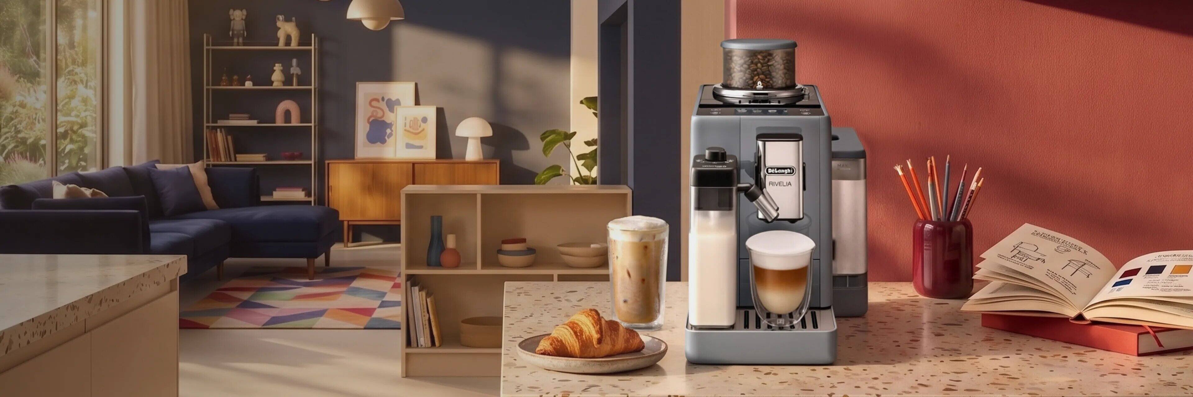 A De'Longhi Rivelia bean-to-cup machine on a terrazzo kitchen counter with a latte, an iced coffee and a croissant, in low autumn sun