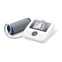 Beurer BM 27 upper arm blood pressure monitor, White — angled side view with cuff