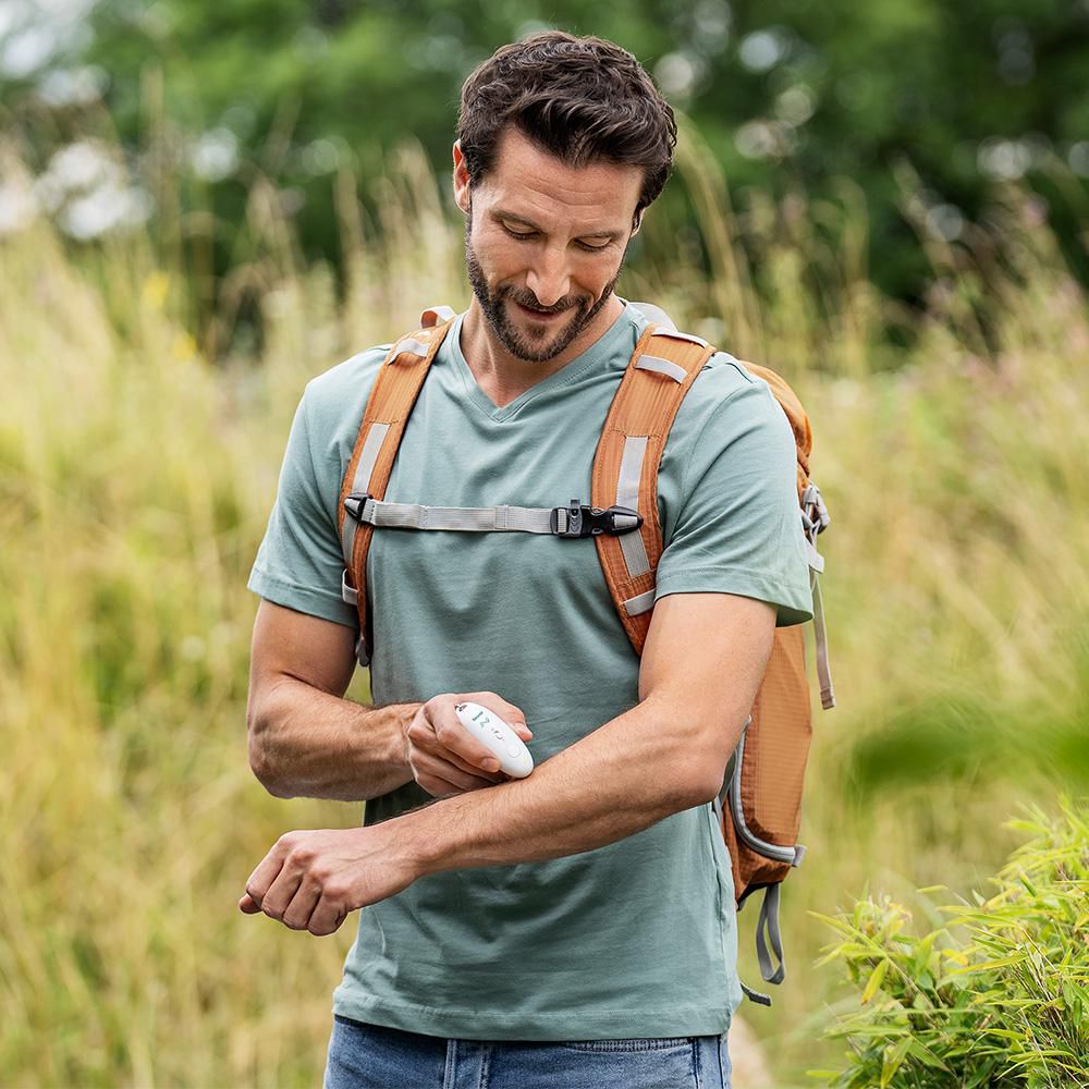 Beurer BR 10 BiteX Travel insect bite healer — in-use lifestyle view outdoors