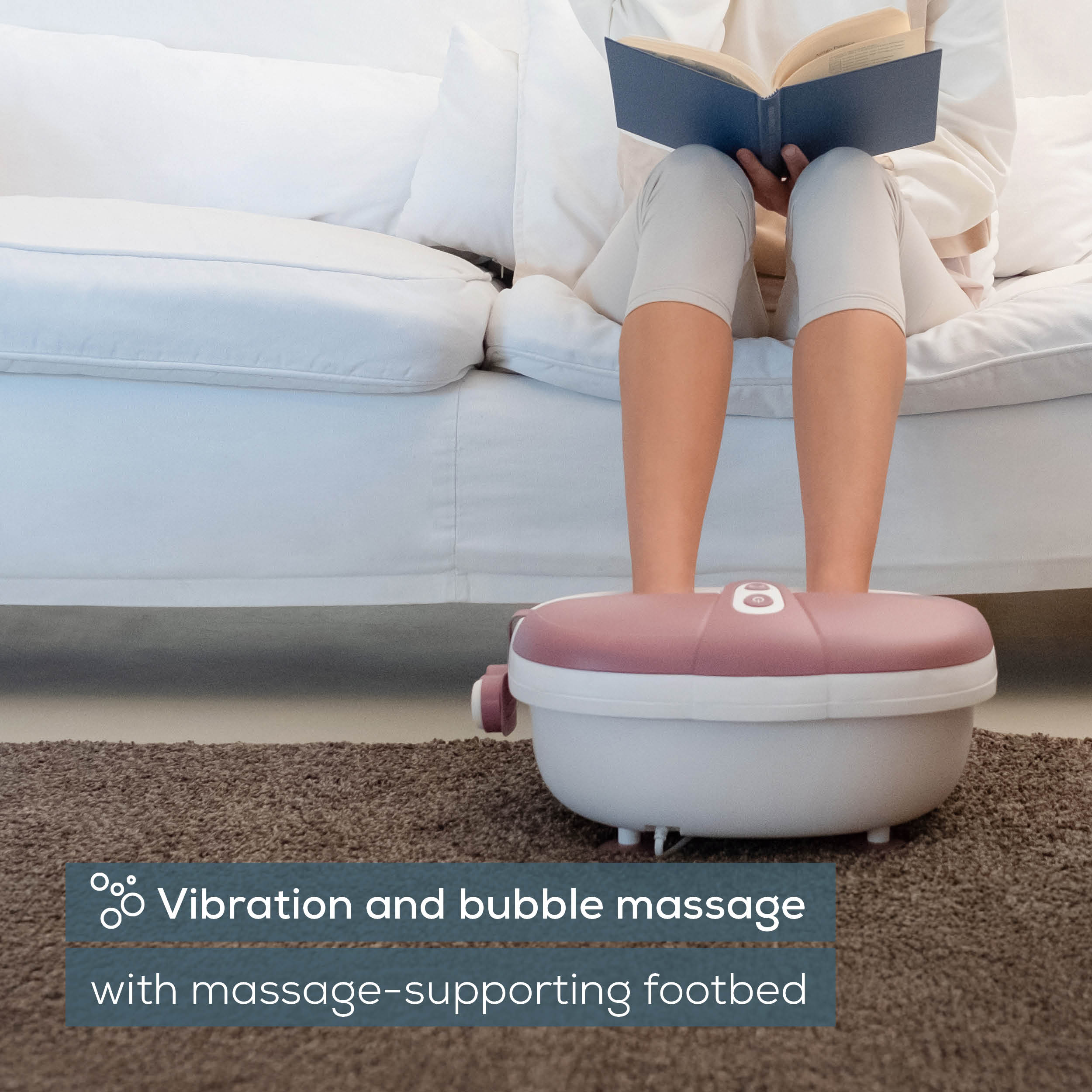 Beurer FB 35 Foot Spa in use, feet in bath with reading person, vibration and bubble massage