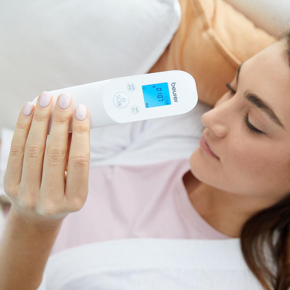 Beurer FT 85 non-contact thermometer — lifestyle view, scanning forehead without touching skin