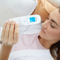 Beurer FT 85 non-contact thermometer — lifestyle view, scanning forehead without touching skin